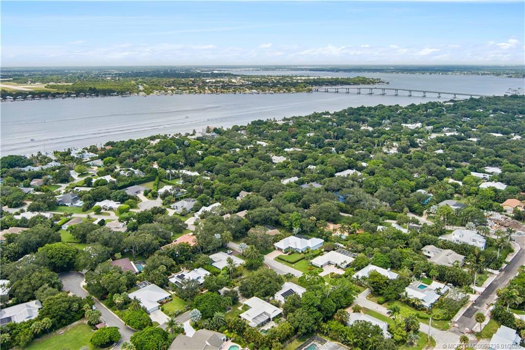 4 Lantana Lane Sewall's Point, FL 34996 - Photo 45 of 47 a view of a yard next to a lake with a city view