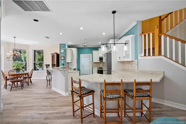 a dining room with furniture and wooden floor