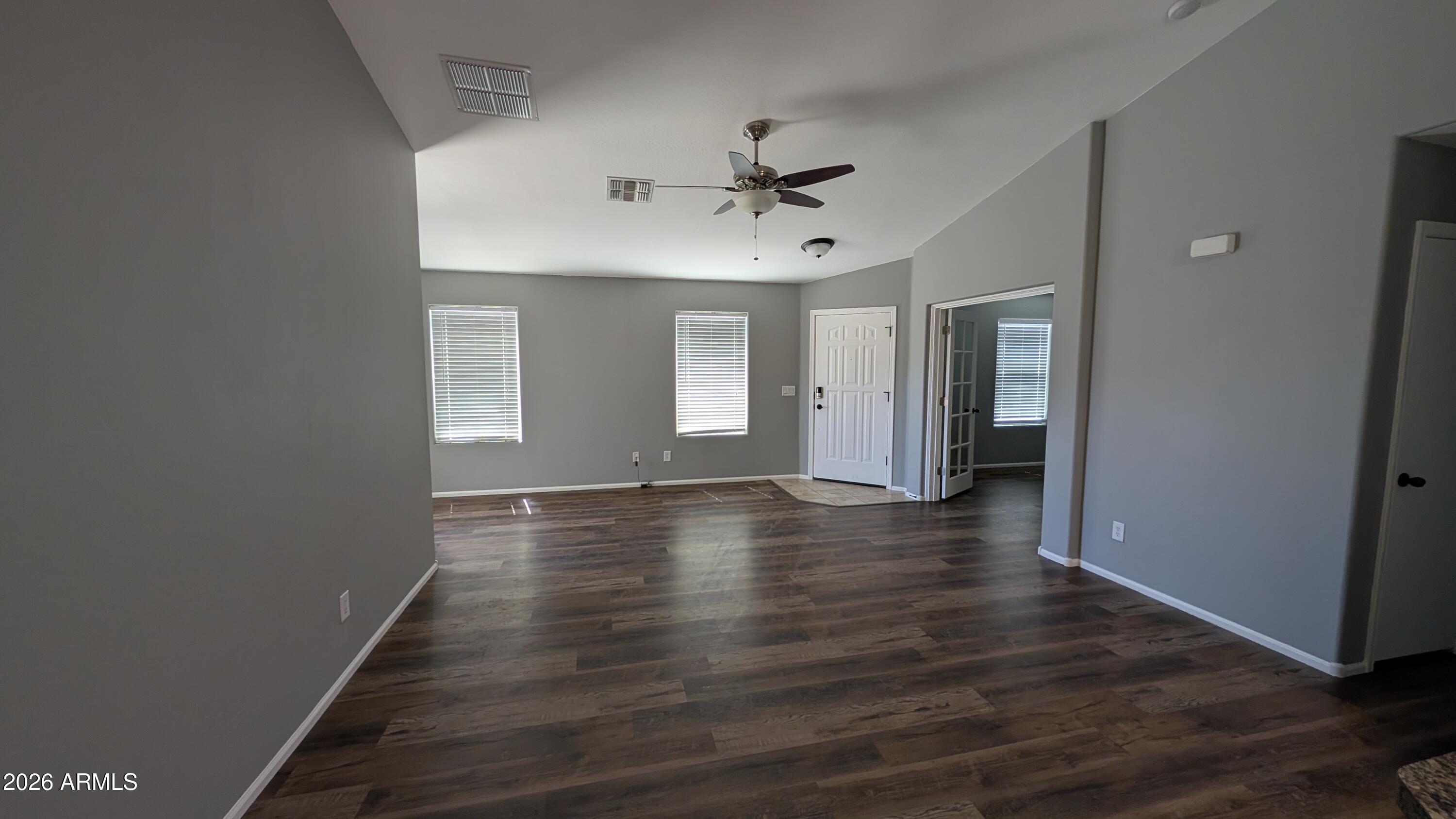 1377 East Pryor Road San Tan Valley, AZ 85140 - Photo 12 of 31 wooden floor in an empty room with a window