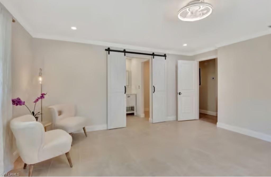 116 Capri Boulevard Naples, FL 34113 - Photo 11 of 29 Sitting room featuring recessed lighting, baseboards, and a barn door
