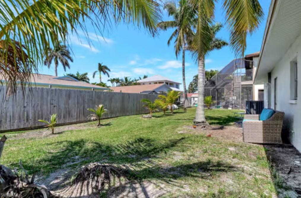 116 Capri Boulevard Naples, FL 34113 - Photo 26 of 29 View of yard with glass enclosure and a fenced backyard