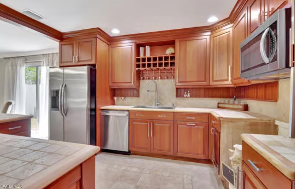 116 Capri Boulevard Naples, FL 34113 - Photo 5 of 29 Kitchen with visible vents, recessed lighting, stainless steel appliances, and a sink