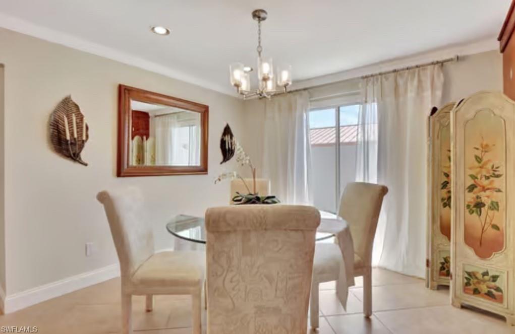 116 Capri Boulevard Naples, FL 34113 - Photo 6 of 29 Dining space with light tile patterned floors, a notable chandelier, recessed lighting, and baseboards
