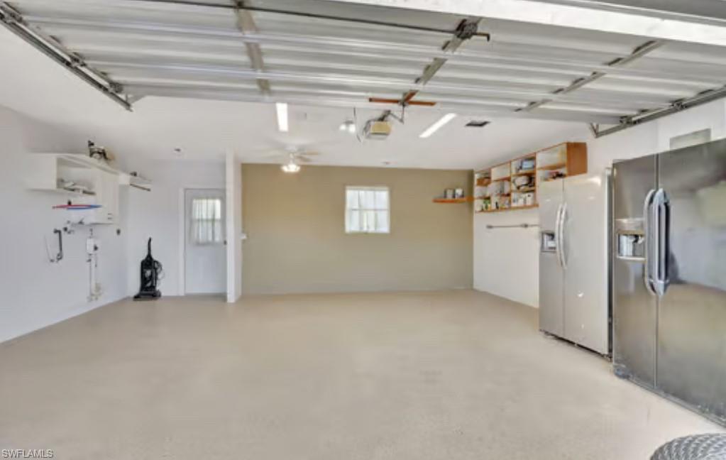 116 Capri Boulevard Naples, FL 34113 - Photo 9 of 29 Garage with refrigerator with ice dispenser and a garage door opener