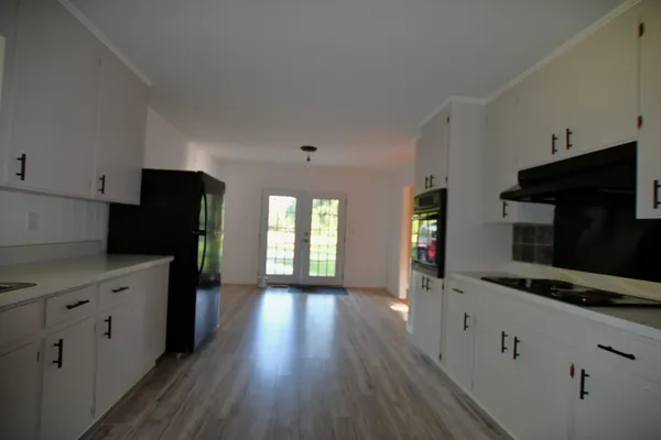 a kitchen with granite countertop stainless steel appliances a stove microwave and refrigerator