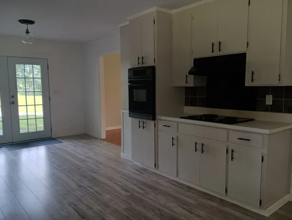 a kitchen with wooden cabinets and a stove top oven