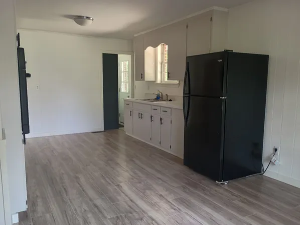 a kitchen with a refrigerator and a sink