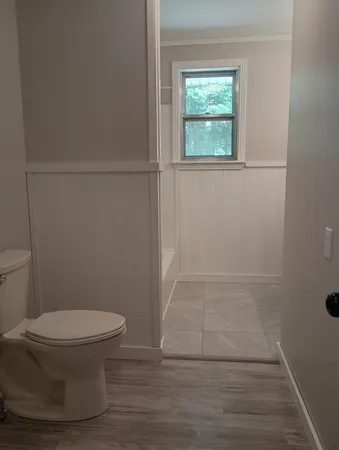 a bathroom with a toilet and a shower