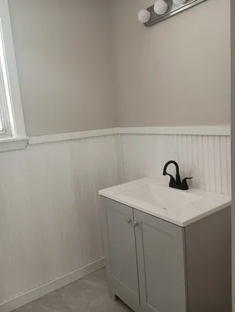 a view of storage utility and utility room with racks on the wall