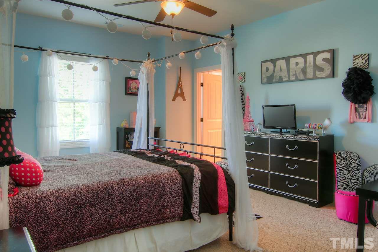 8333 Henderson Road Apex, NC 27539 - Photo 22 of 25 a bedroom with a bed and a window
