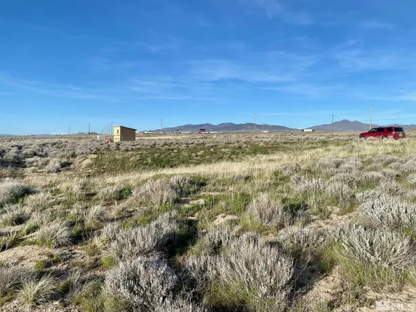 a view of a field with a mountain in the background
