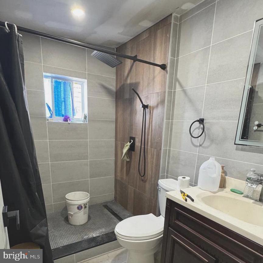 1040 Scott Street Kulpmont, PA 17834 - Photo 5 of 10 a white toilet sitting next to a bathroom sink and a shower