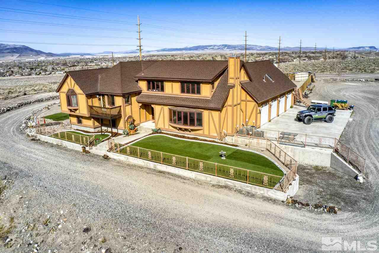 650 Desert Shadows Lane Fernley, NV 89408 - Photo 1 of 39 an aerial view of a house with a ocean view