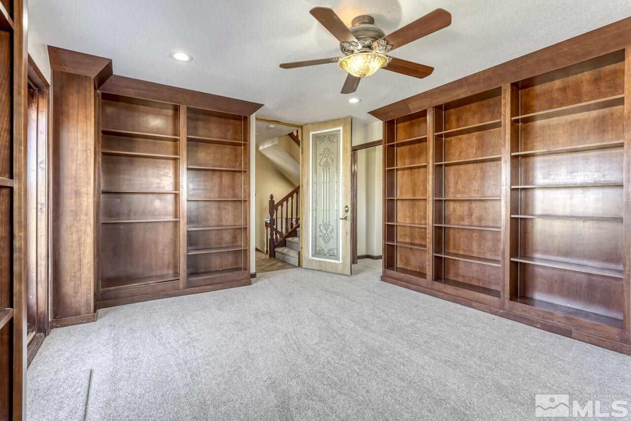 650 Desert Shadows Lane Fernley, NV 89408 - Photo 13 of 39 a view of an empty room with a ceiling fan