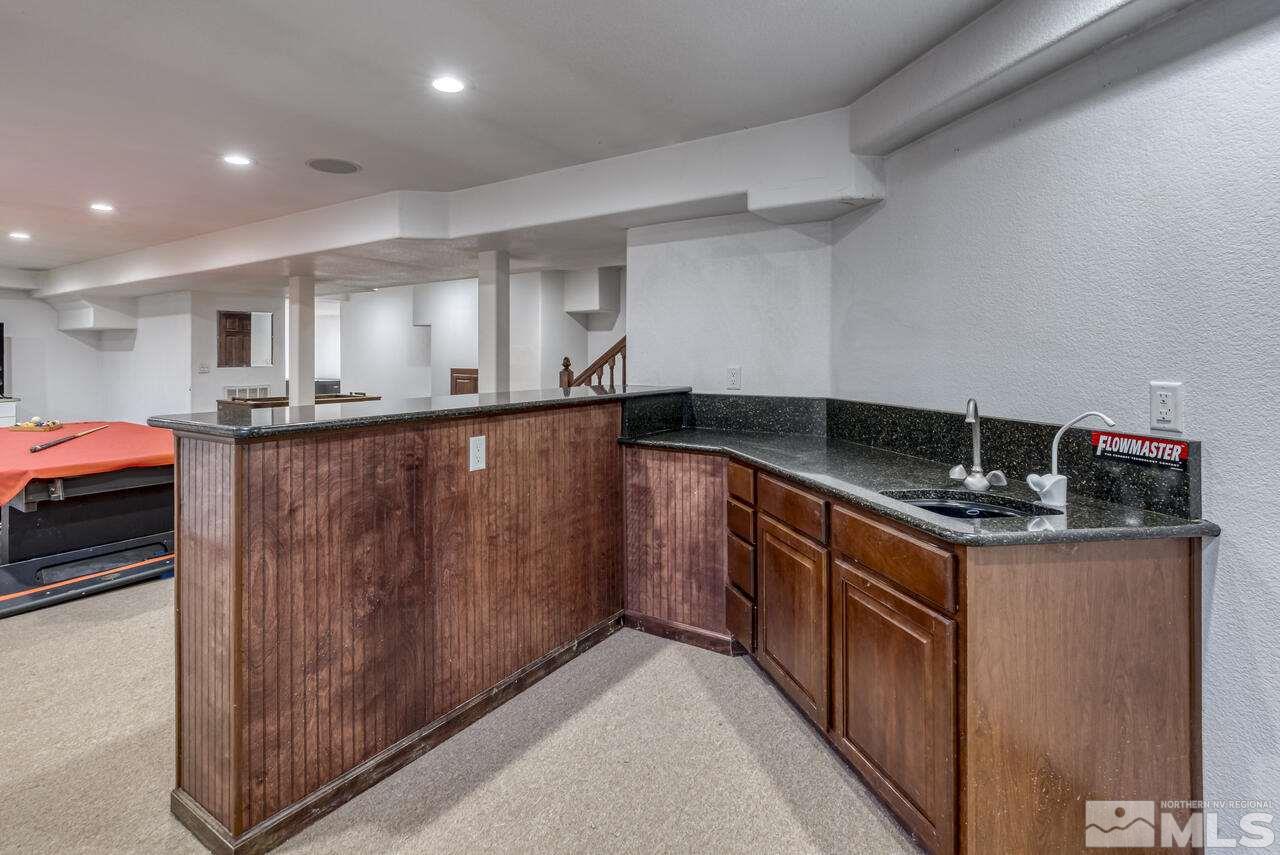 650 Desert Shadows Lane Fernley, NV 89408 - Photo 16 of 39 a kitchen with granite countertop a sink and a stove