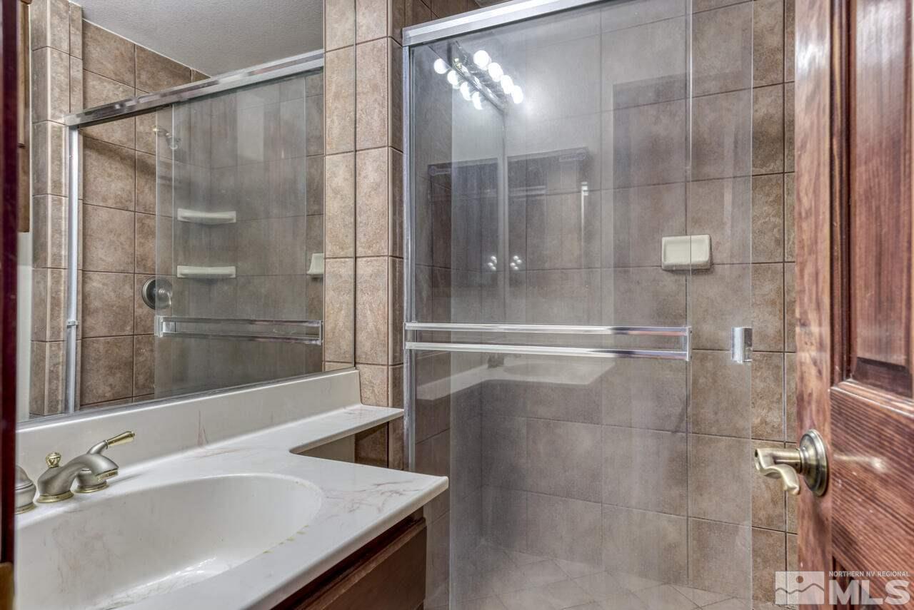 650 Desert Shadows Lane Fernley, NV 89408 - Photo 21 of 39 a bathroom with a bathtub and a shower