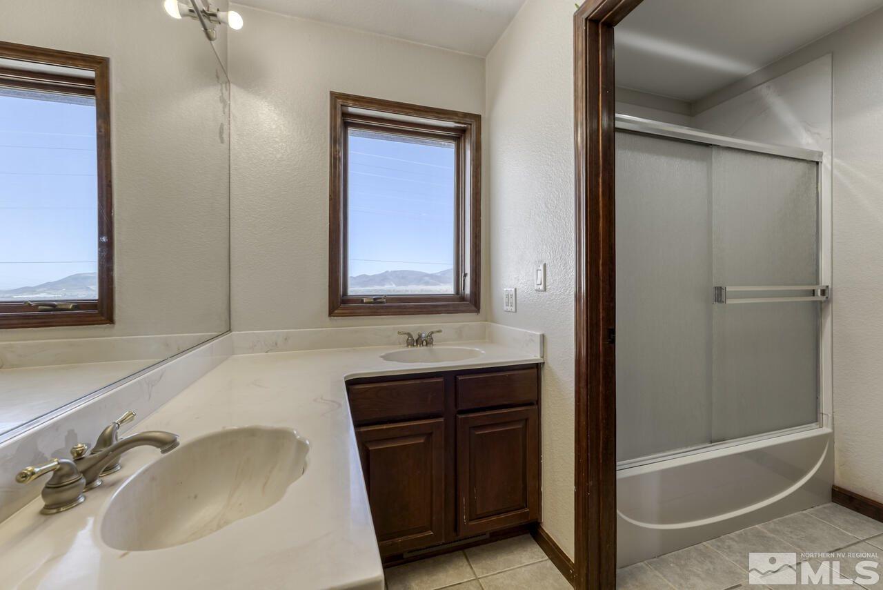 650 Desert Shadows Lane Fernley, NV 89408 - Photo 22 of 39 a bathroom with a bathtub and a sink