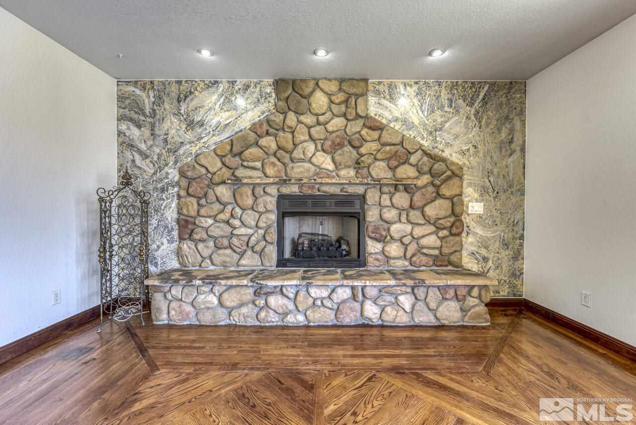 650 Desert Shadows Lane Fernley, NV 89408 - Photo 25 of 39 a view of wooden floor with a fireplace