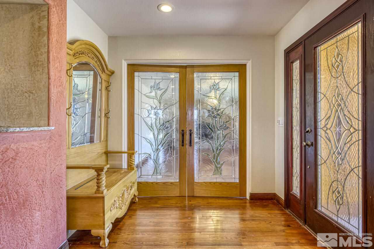 650 Desert Shadows Lane Fernley, NV 89408 - Photo 28 of 39 a view of an entryway with wooden floor and door