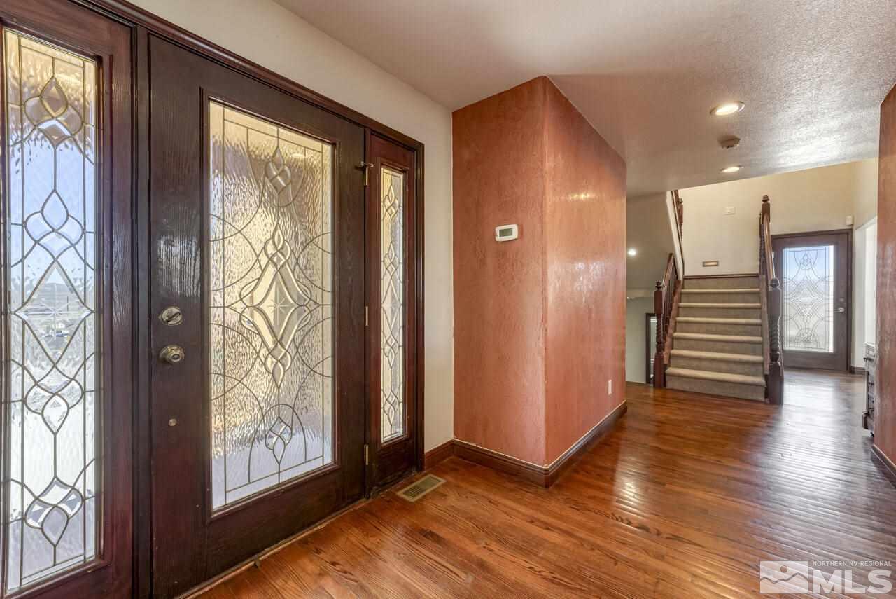 650 Desert Shadows Lane Fernley, NV 89408 - Photo 29 of 39 an empty room with wooden floor and windows