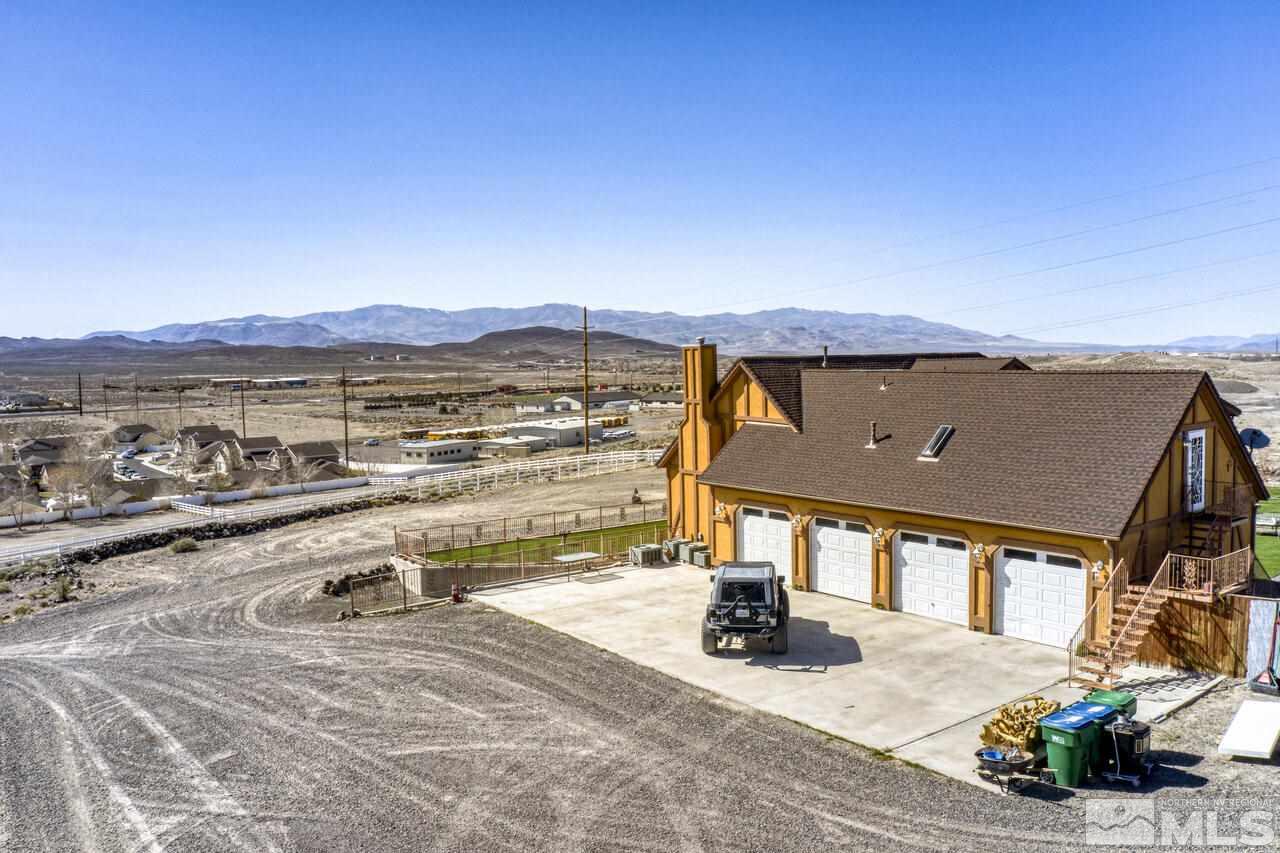 650 Desert Shadows Lane Fernley, NV 89408 - Photo 33 of 39 an outdoor view of a house with a yard