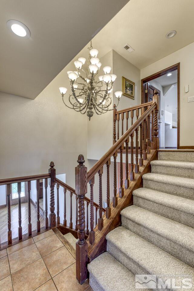 650 Desert Shadows Lane Fernley, NV 89408 - Photo 7 of 39 a view of staircase with railing and a chandelier
