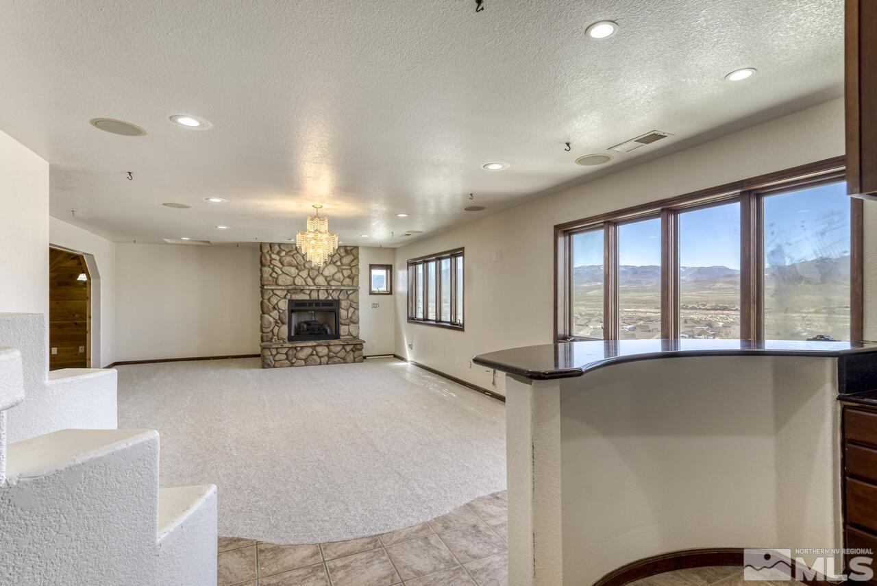 650 Desert Shadows Lane Fernley, NV 89408 - Photo 8 of 39 a view of a livingroom with furniture staircase and a kitchen