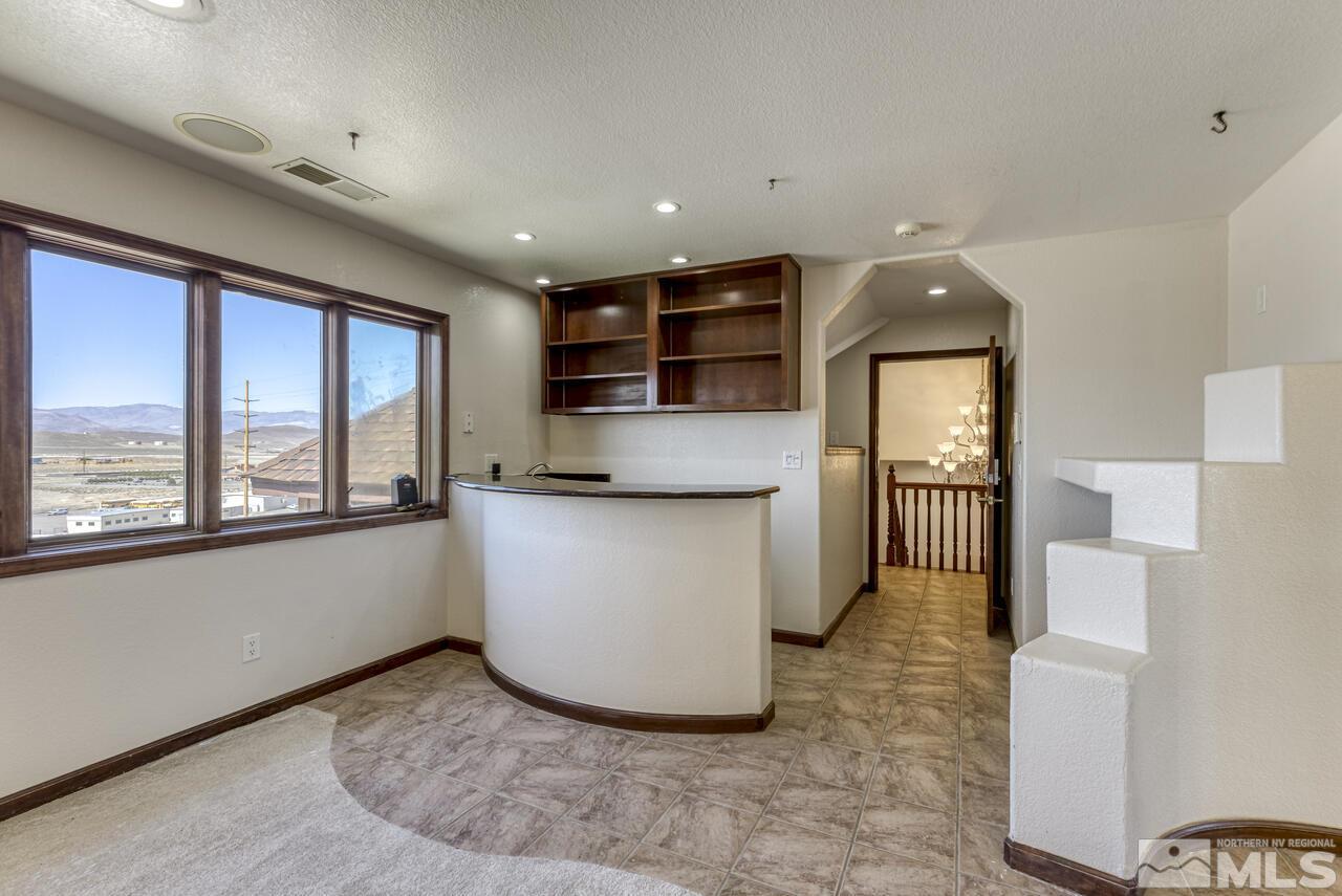 650 Desert Shadows Lane Fernley, NV 89408 - Photo 9 of 39 a view of a kitchen with furniture and staircase