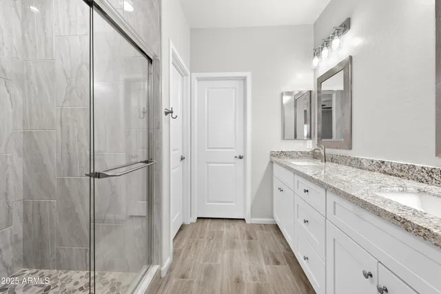 a spacious bathroom with a granite countertop sink mirror and double
