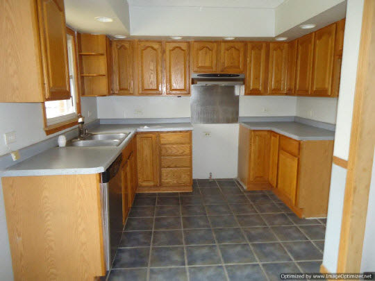 11135 East Fisher Road Rochelle, IL 61068 - Photo 4 of 11 a kitchen with a sink a stove and a refrigerator
