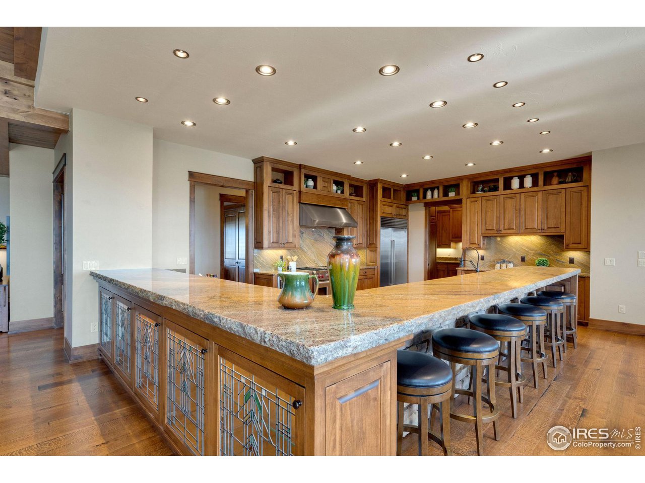39759 Pinnacle Ridge Court Severance, CO 80610 - Photo 11 of 40 a kitchen with stainless steel appliances granite countertop a kitchen island a stove and a sink
