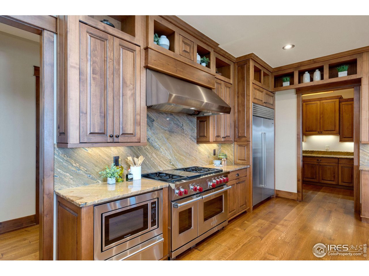 39759 Pinnacle Ridge Court Severance, CO 80610 - Photo 13 of 40 a kitchen with stainless steel appliances granite countertop a stove and a refrigerator