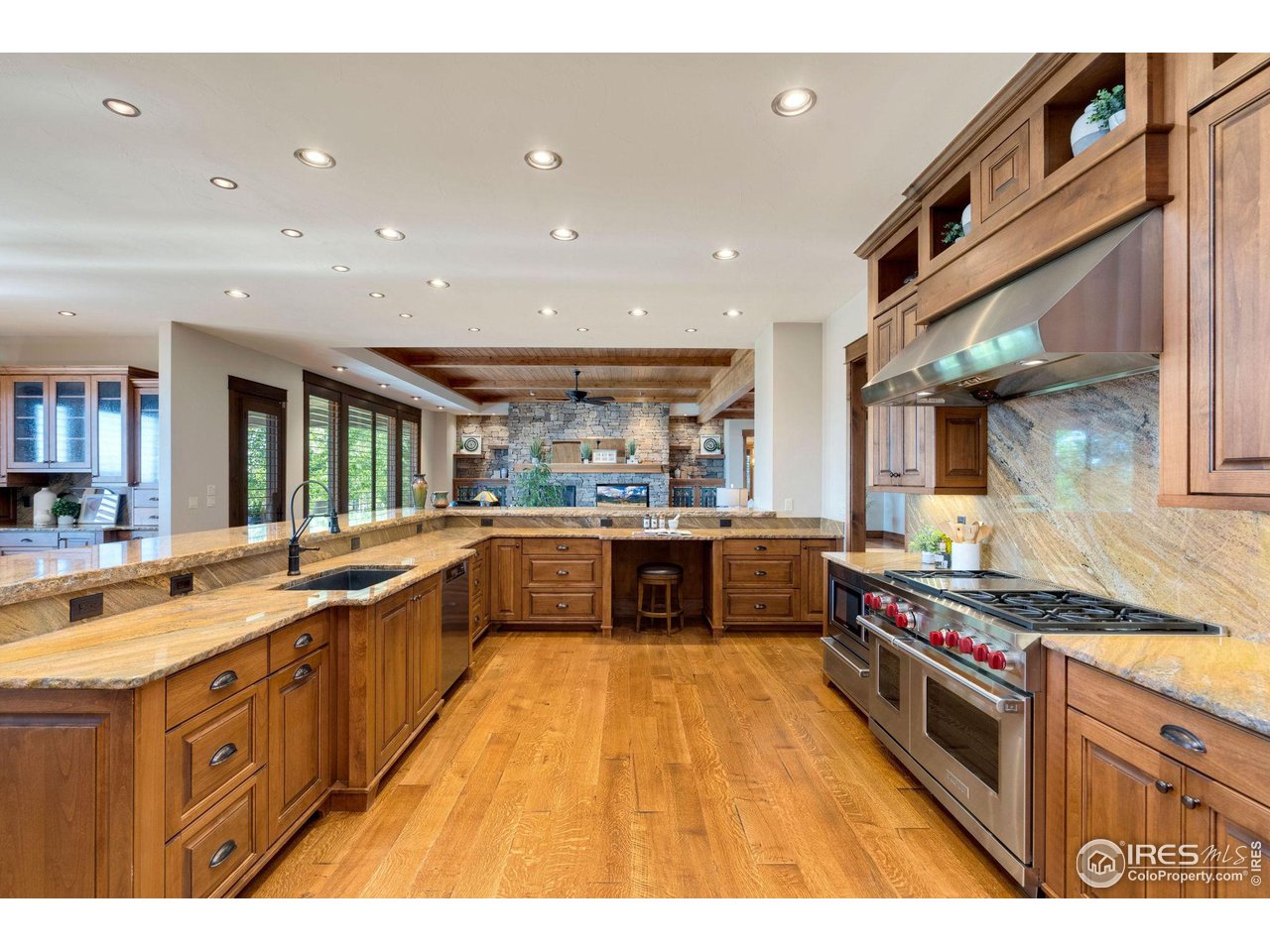 39759 Pinnacle Ridge Court Severance, CO 80610 - Photo 15 of 40 a large kitchen with stainless steel appliances granite countertop a large counter top and a stove