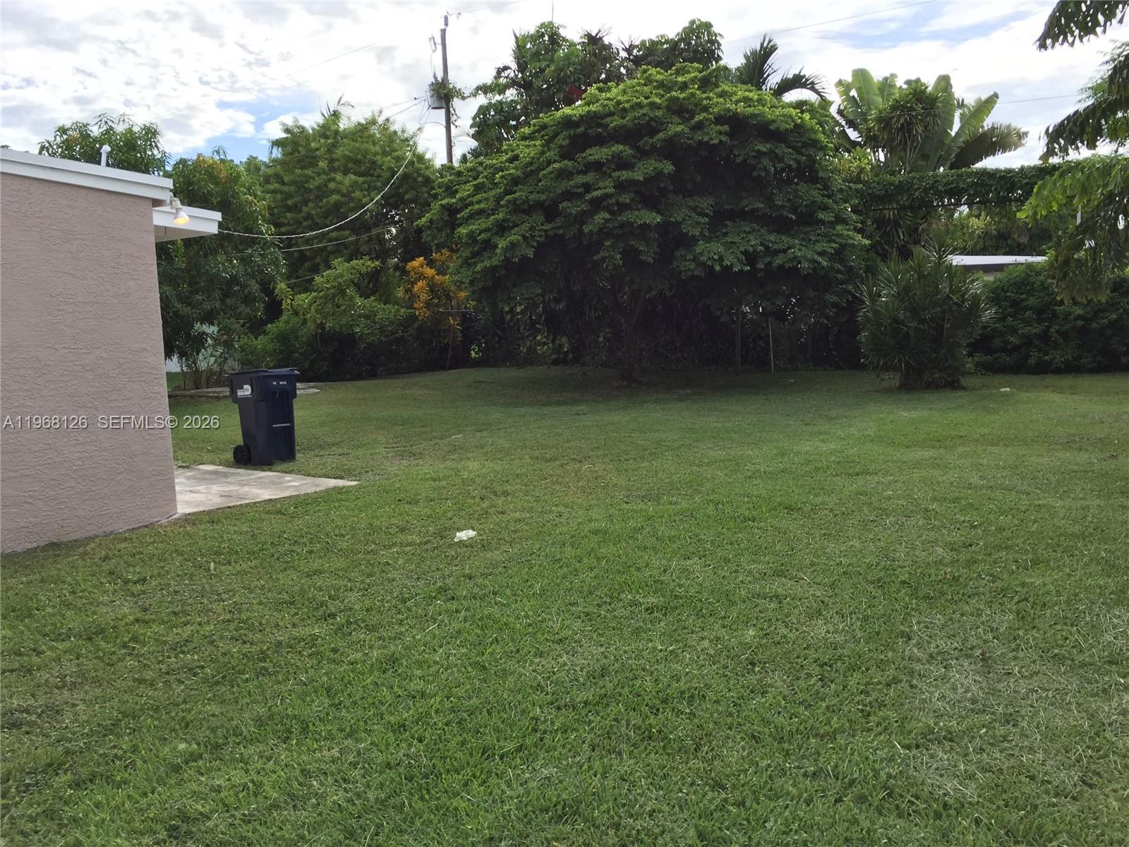 4700 Southwest 97th Avenue, Unit 4700 Miami, FL 33165 - Photo 3 of 9 a backyard of a house with lots of green space