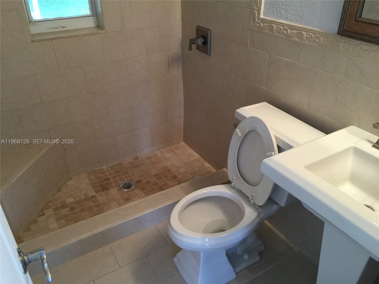 4700 Southwest 97th Avenue, Unit 4700 Miami, FL 33165 - Photo 6 of 9 a bathroom with a sink and a toilet