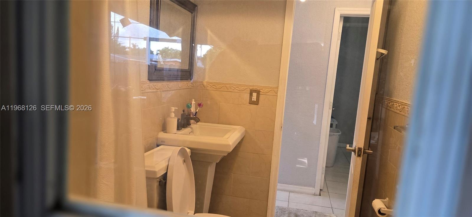 4700 Southwest 97th Avenue, Unit 4700 Miami, FL 33165 - Photo 9 of 9 a bathroom with a sink a toilet and shower