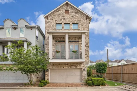 a front view of a residential apartment building with a yard