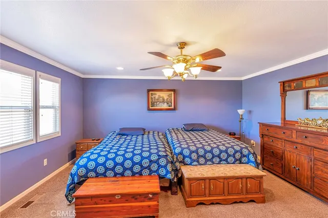 a bedroom with a bed and dresser with mirror