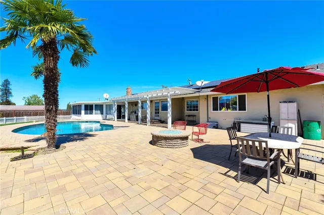 a view of a swimming pool with chairs in patio