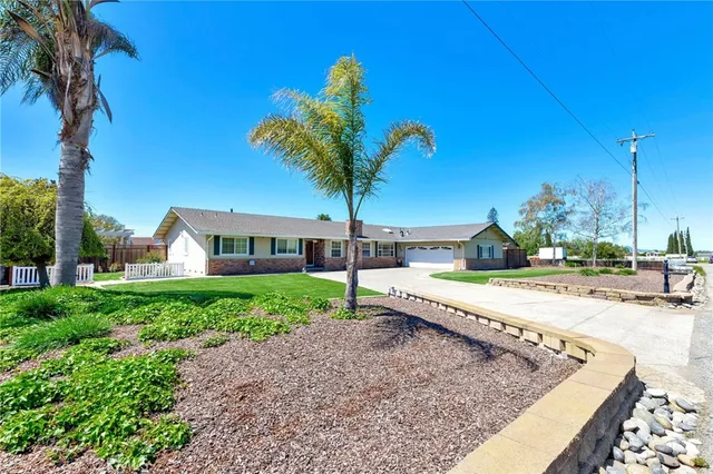 a house with lots of trees in the background