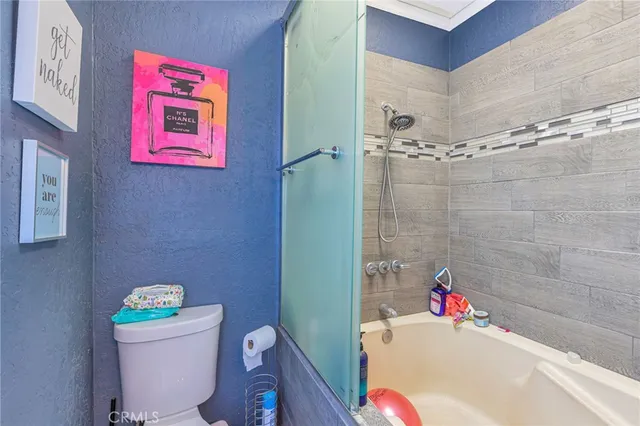 a bathroom with a tub and shower