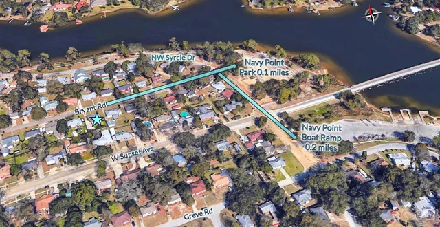 a front view of a building with glass windows and sitting area