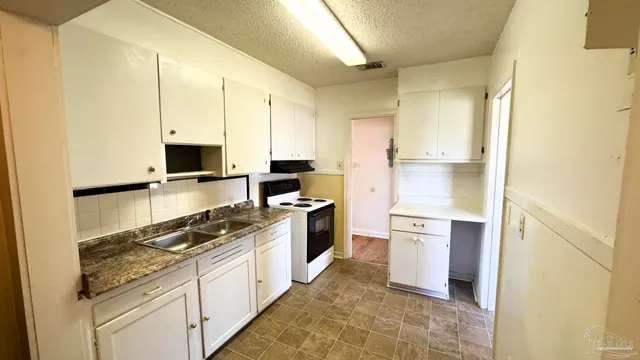 a kitchen with a sink stove and refrigerator
