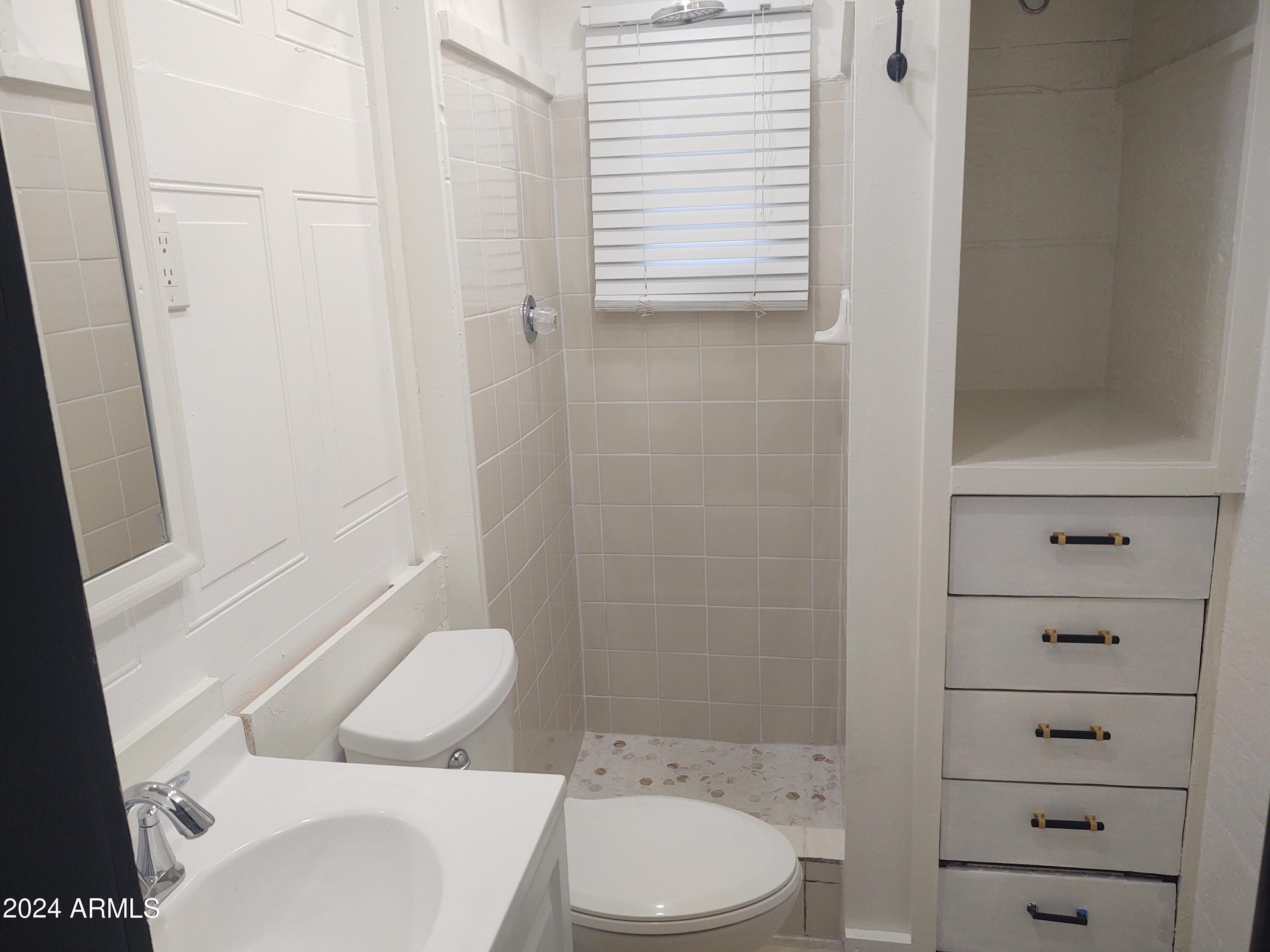 1625 East Pinchot Avenue Phoenix, AZ 85016 - Photo 2 of 6 a white toilet sitting next to a bathroom sink