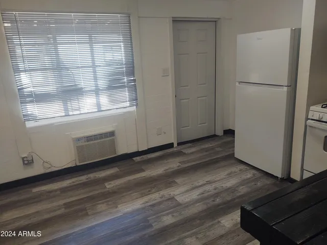 a view of a kitchen with wooden floor and electronic appliances