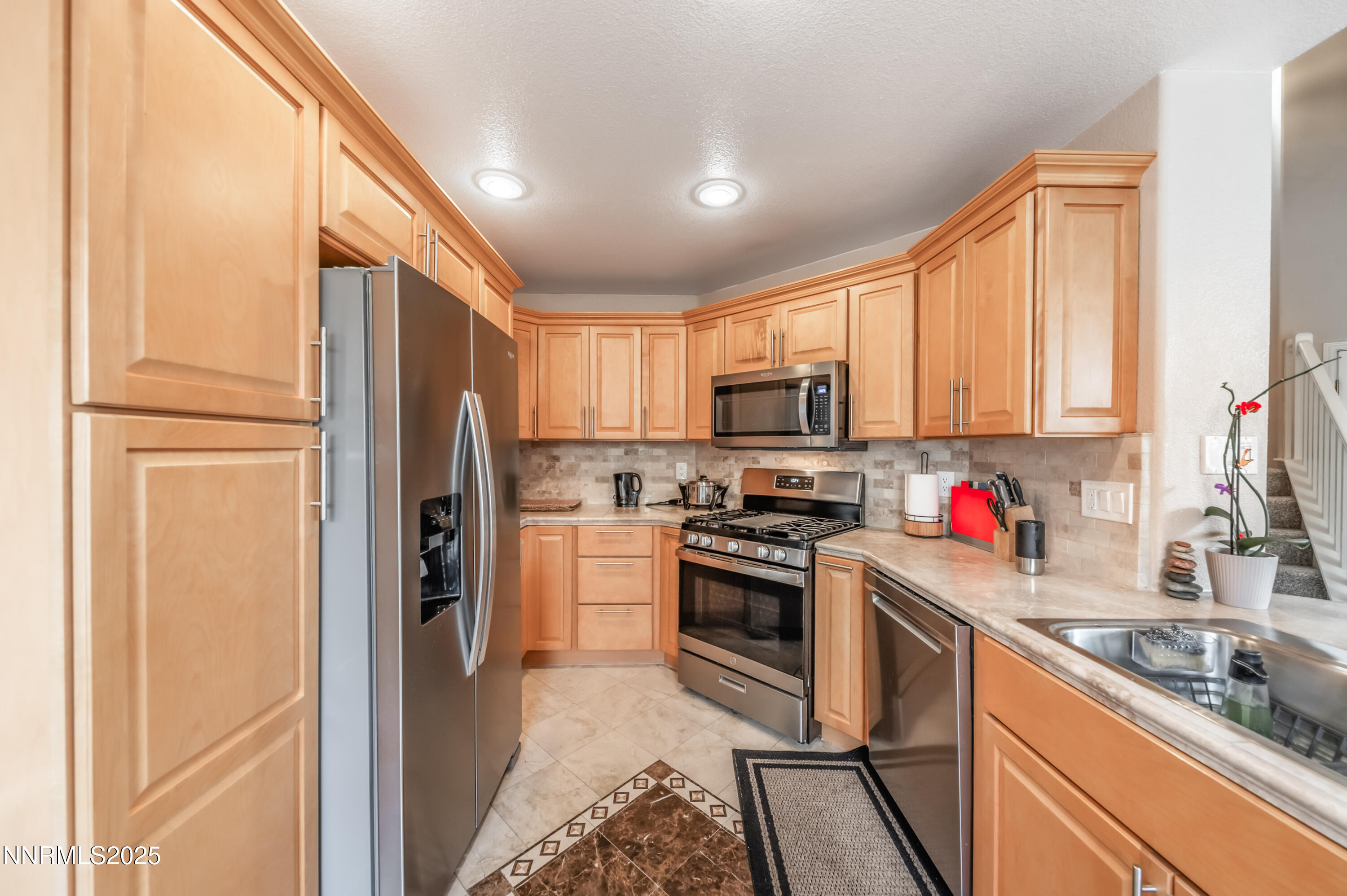 5722 Golden Eagle Drive Reno, NV 89523 - Photo 12 of 32 a kitchen with stainless steel appliances granite countertop a refrigerator stove microwave and sink