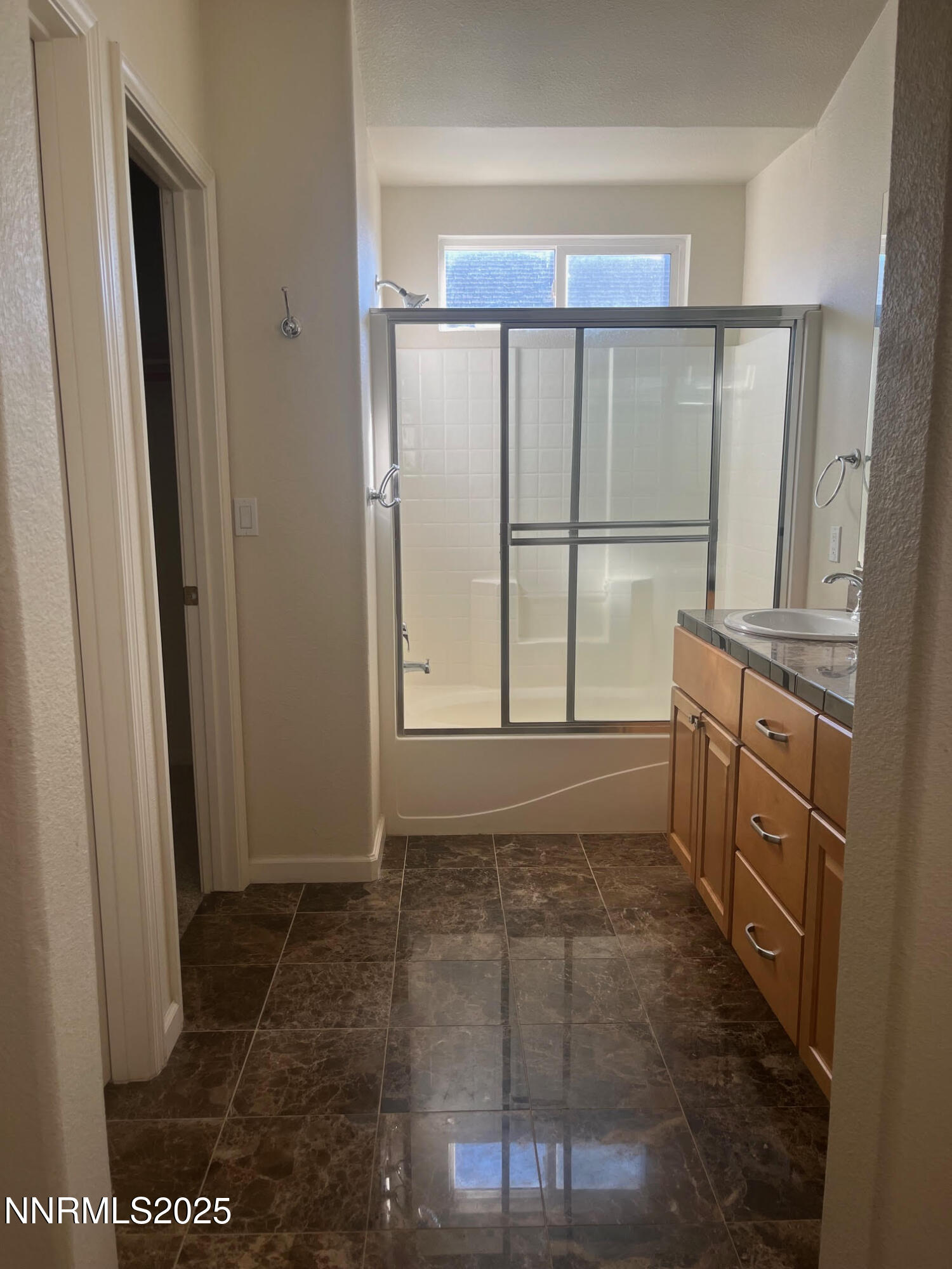 5722 Golden Eagle Drive Reno, NV 89523 - Photo 18 of 32 a bathroom with a granite countertop sink and a shower