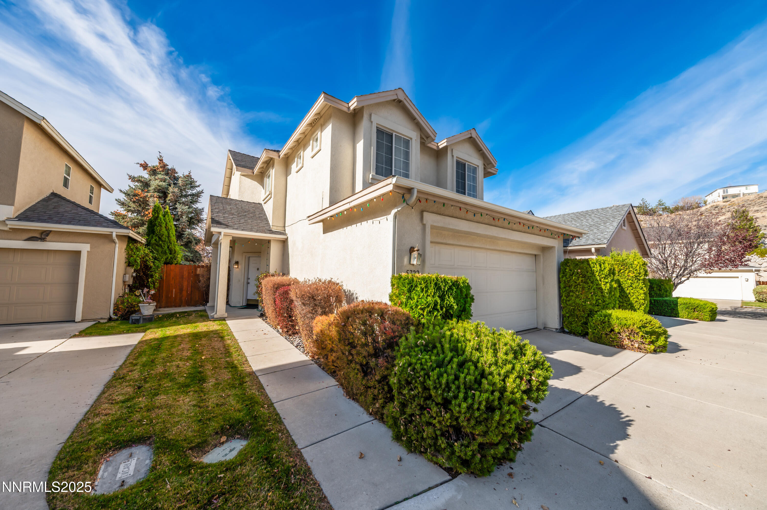 5722 Golden Eagle Drive Reno, NV 89523 - Photo 2 of 32 a front view of a house with a garden