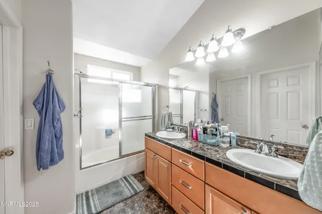 a bathroom with a double vanity sink and a mirror