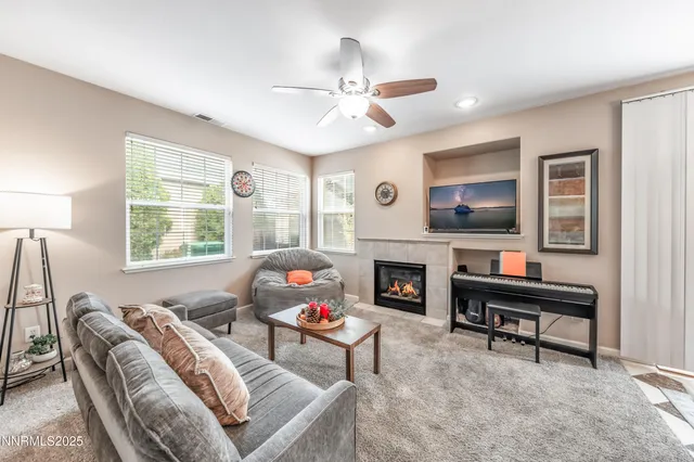 a living room with furniture a fireplace and a flat screen tv